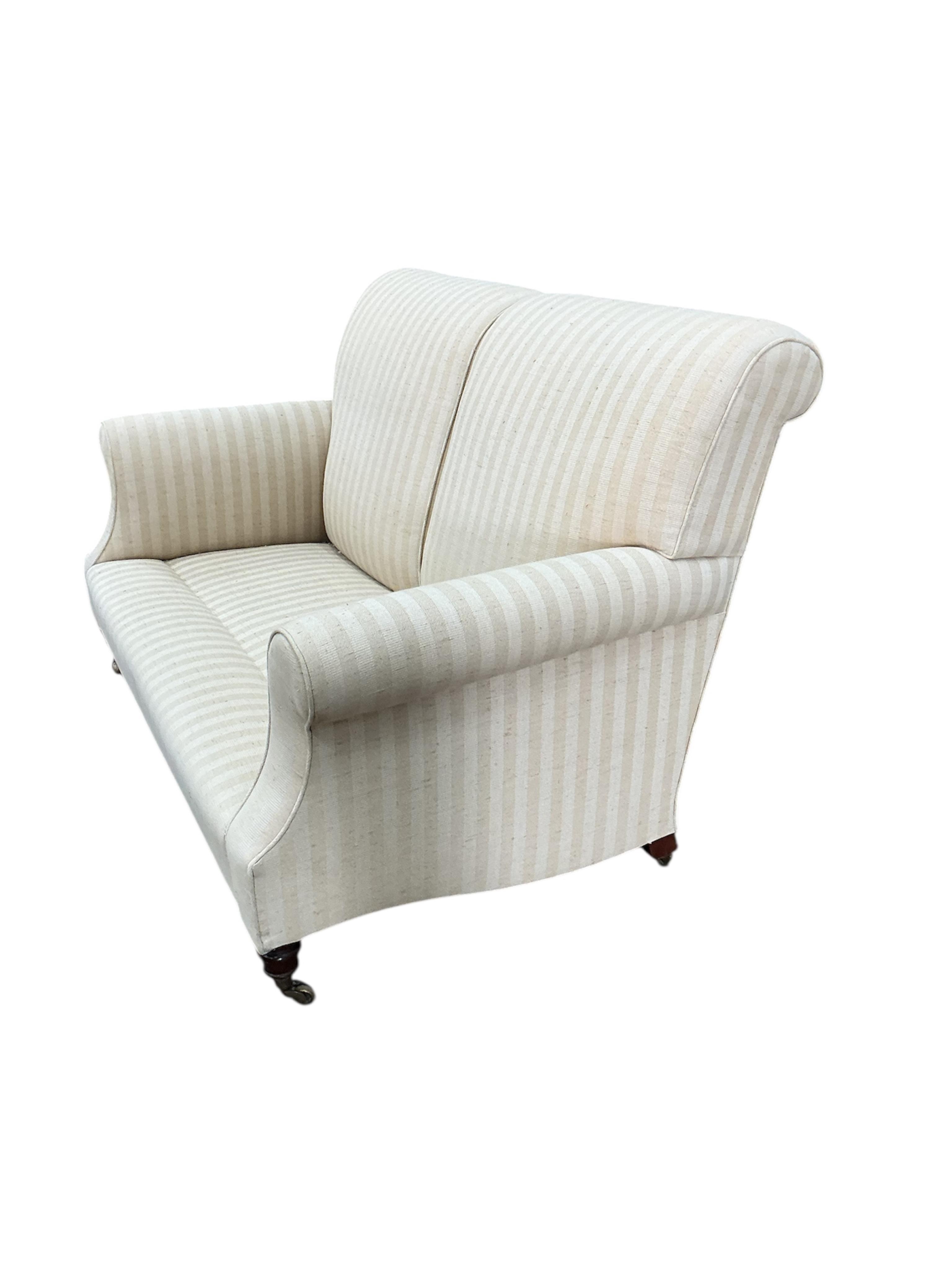 A Victorian style upholstered scroll arm two seater settee, width 150cm, depth 76cm, height 92cm